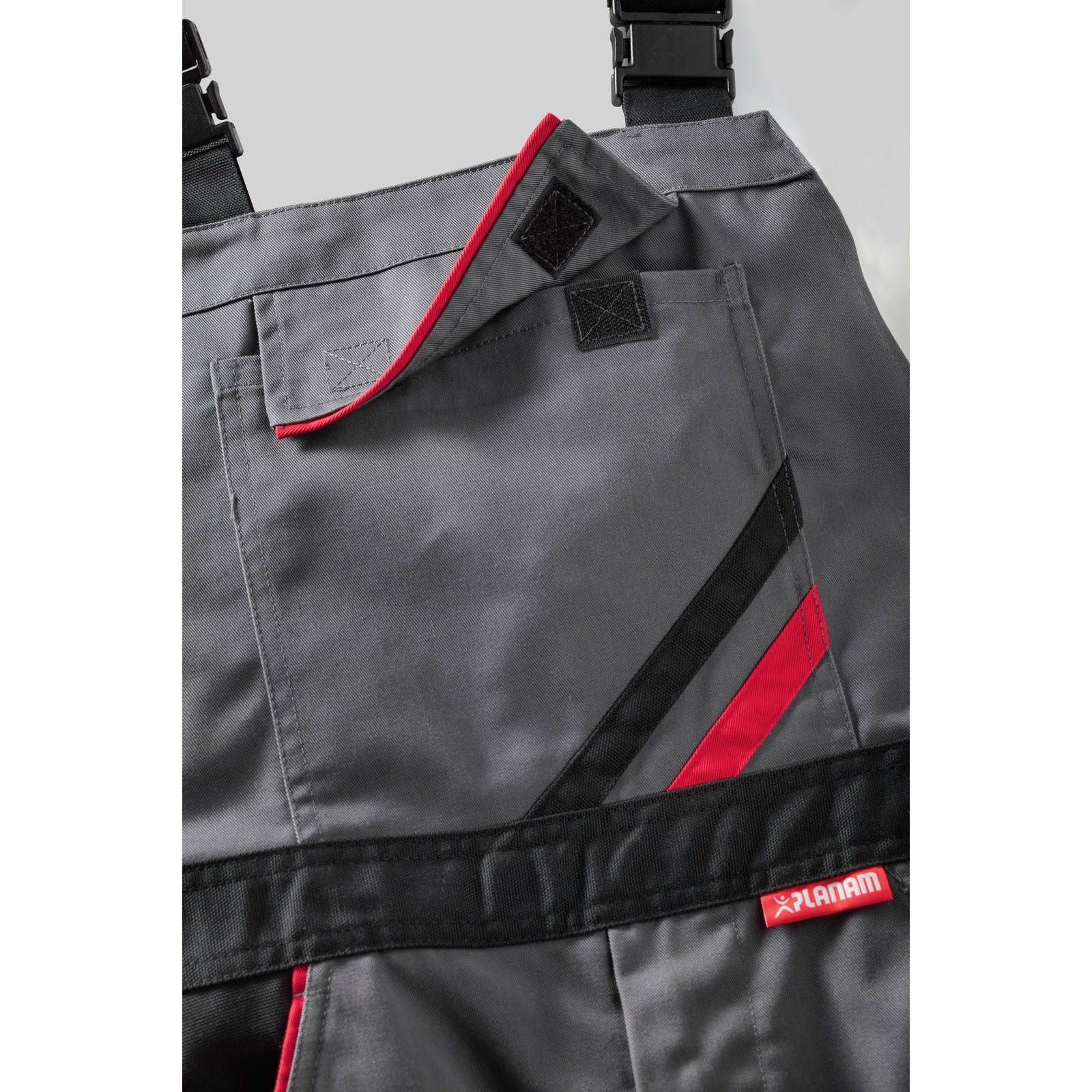 Planam Highline Dungarees zinc/slate/red - The bib pocket with flap and Velcro closure provides optimal storage space.