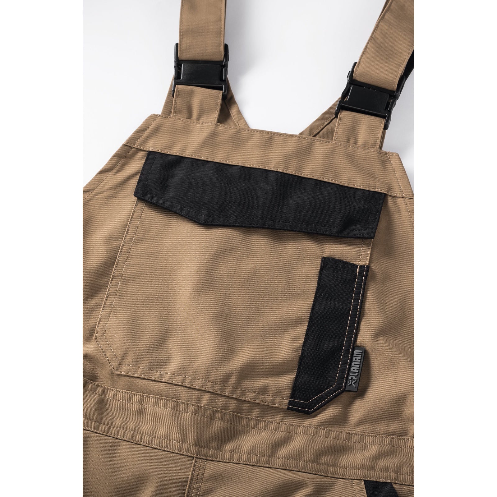 Planam Norit Women's dungarees sand/black - The bib with zip closure and bib pocket provide plenty of storage space.